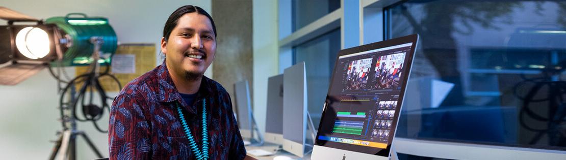 A Digital Arts student works on a video at a computer in a Pima West campus video lab